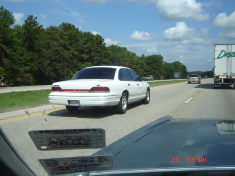 1988 Ford LTD Crown Victoria - A white 1992 Ford Crown Victoria travels down the highway, seen from another vehicle.