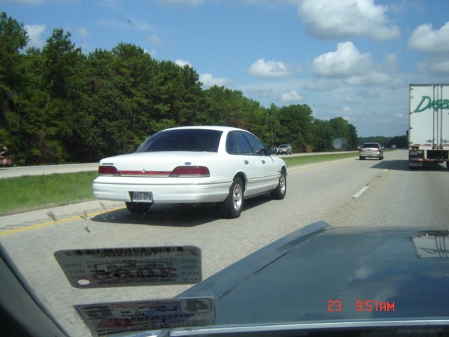 Rear view of a white 1992 Ford Crown Victoria on the highway