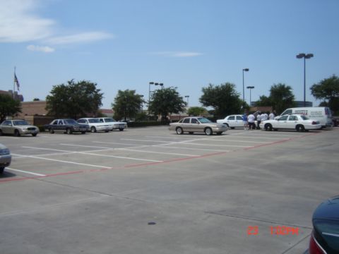 1988 Ford LTD Crown Victoria - Several Ford Crown Victoria LTDs and other vehicles are parked in a lot on a sunny day.