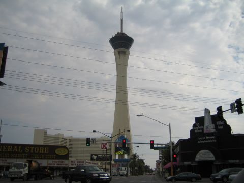 1985 Ford Mustang - View of the Stratosphere Tower from a street in Las Vegas, with traffic and buildings visible.