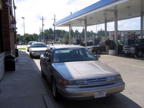 2000 Ford Crown Victoria - Silver 2000 Ford Crown Victoria at a gas station, with other vehicles visible.