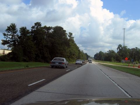 2000 Ford Crown Victoria - A view from a car driving on a highway with several other vehicles on the road.
