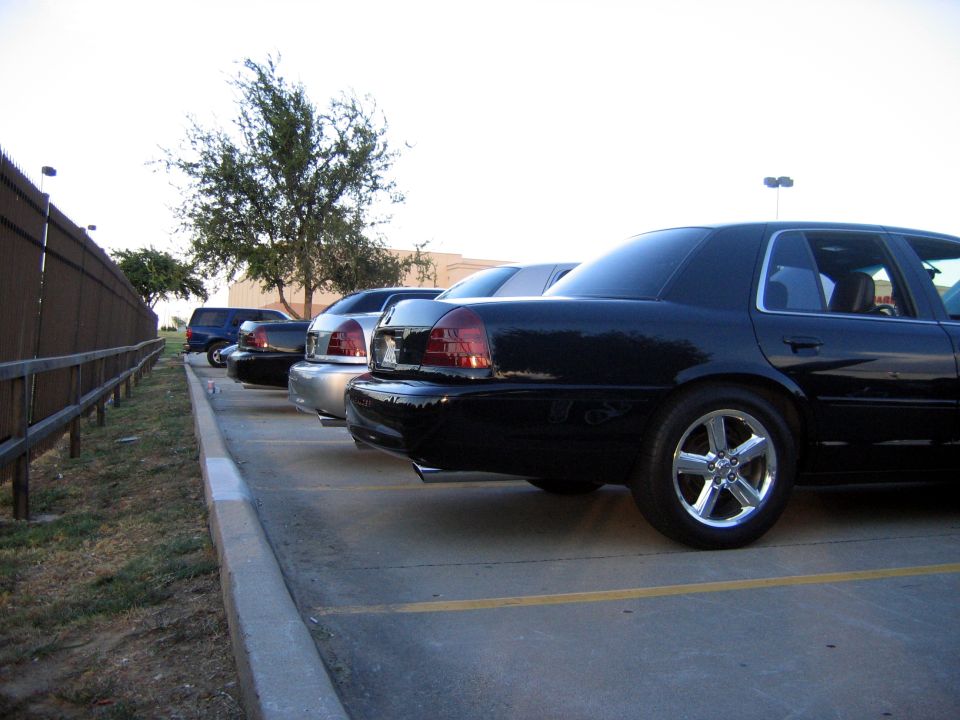 Black 2000 Ford Crown Victoria parked in a lot, rear quarter view
