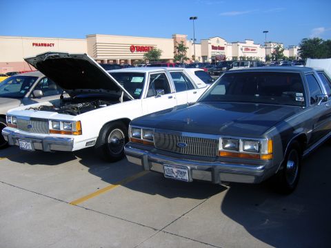 2000 Ford Crown Victoria - Two Ford Crown Victorias parked in a lot with a Target store in the background.