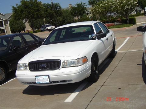 1988 Ford LTD Crown Victoria - White Ford Crown Victoria parked in a lot with another car nearby.