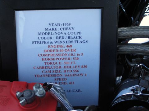 2000 Ford Crown Victoria - Engine-bay show placard for a 1969 Chevy Nova coupe listing a 468 (.060 over) big-block, 10.1:1 compression, 530 hp, 500 ft-lb, Holley 830,…