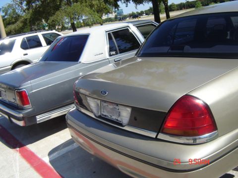 1988 Ford LTD Crown Victoria - Rear view of a gold 1998 Ford Crown Victoria parked next to a silver sedan.