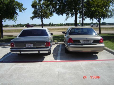 1988 Ford LTD Crown Victoria - Two Ford Crown Victorias are parked in a lot on a sunny day.