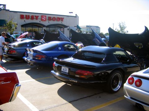 2000 Ford Crown Victoria - Dodge Vipers are displayed with their hoods open at an outdoor car meet.