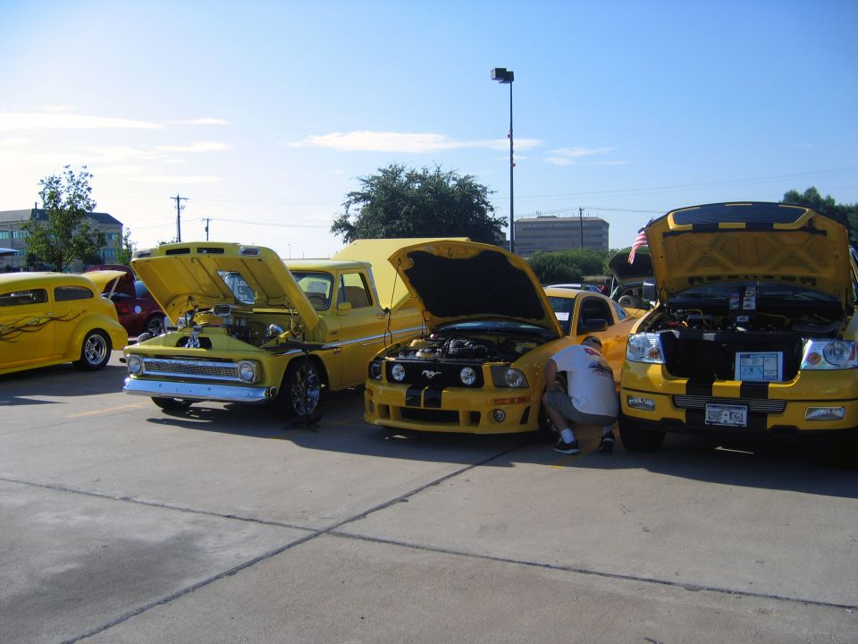Yellow Ford F-150 truck front view with hood open