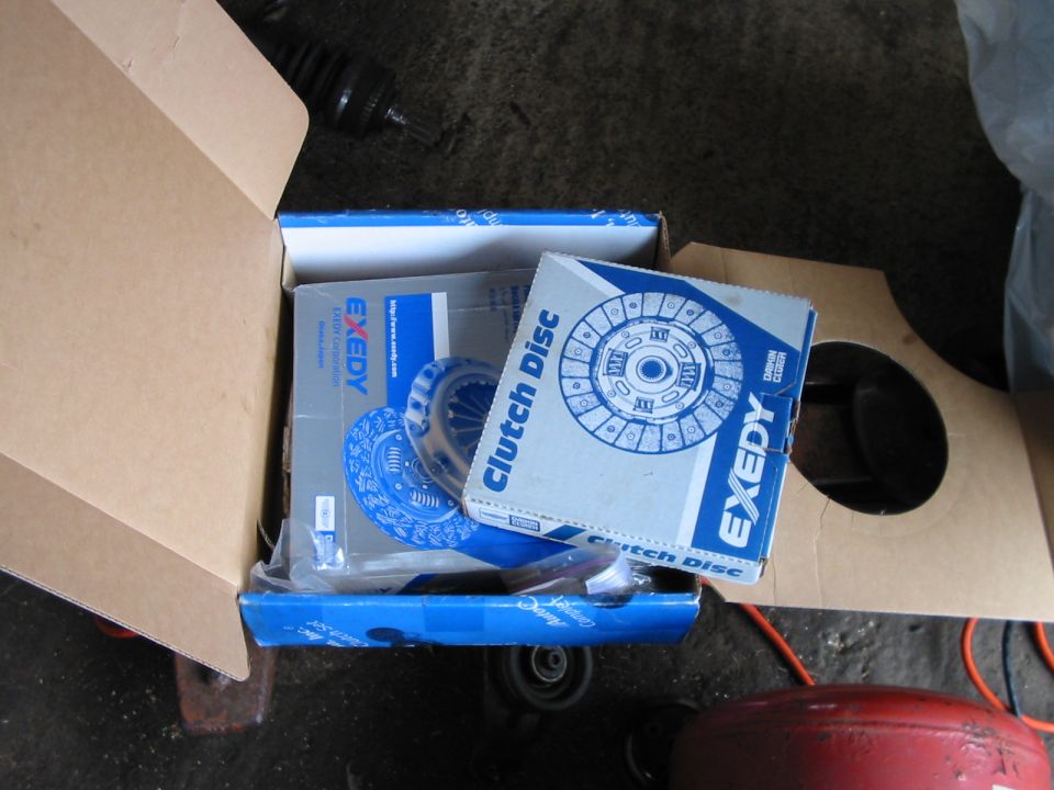 Open Exedy clutch disc box with axle shaft resting in the carton