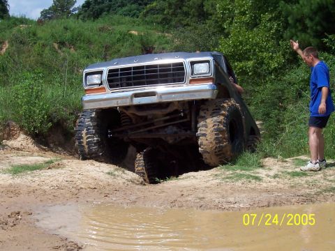 1987 Ford Bronco - A man watches a modified Ford Bronco tackle an off-road obstacle on July 24, 2005.