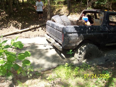 1987 Ford Bronco - This 1987 Ford Bronco is deep in the mud, with a spare tire in the bed.