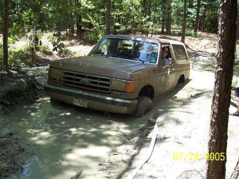 1987 Ford Bronco - This 1987 Ford Bronco is deep in the mud during an off-road excursion.