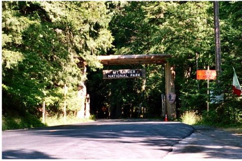 1979 Ford Bronco - The entrance to Mt. Rainier National Park is marked by a rustic wooden archway and a sign.