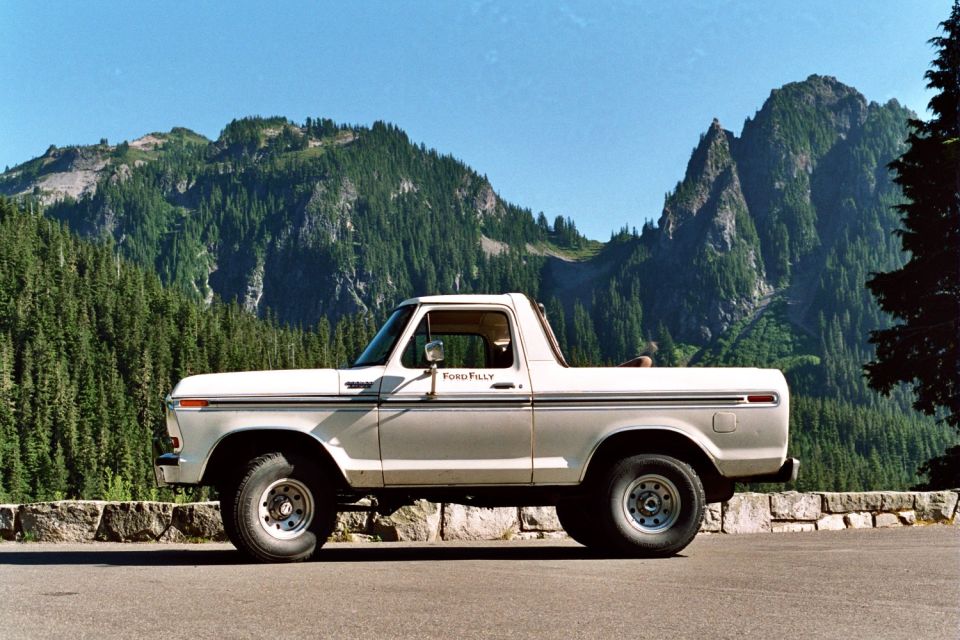 Side view of a white 1979 Ford Bronco parked on a scenic overlook