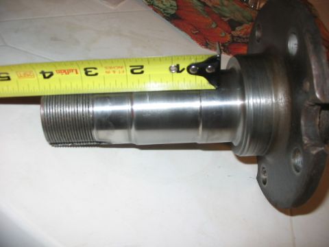 1995 Ford Bronco - Metal axle part being measured with a tape measure.
