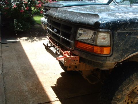 1993 Ford Bronco - A dark green Ford truck, likely a 1992 model, is parked next to another vehicle, with a hi-lift jack mounted on its front bumper.