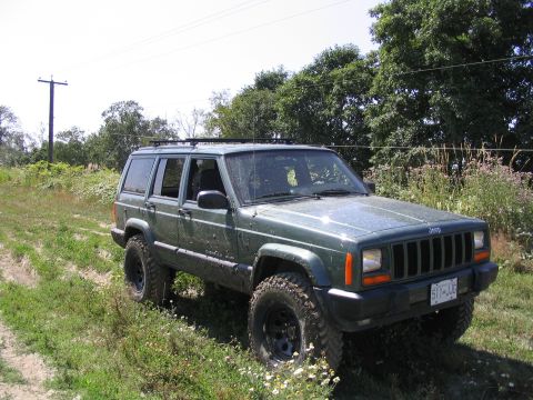 2000 Jeep Cherokee - This 2000 Jeep Cherokee is seen parked off-road on a sunny day.