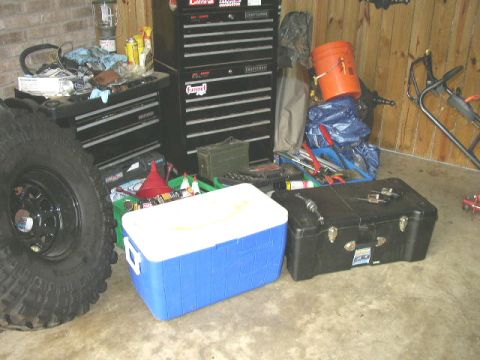 1995 Ford Bronco - A collection of tools and storage containers are organized in a garage setting.
