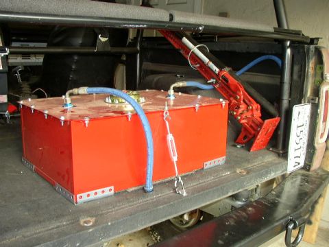1995 Ford Bronco - An aftermarket red fuel tank and a Hi-Lift jack are visible in the bed of a truck, with a license plate reading 15517A.