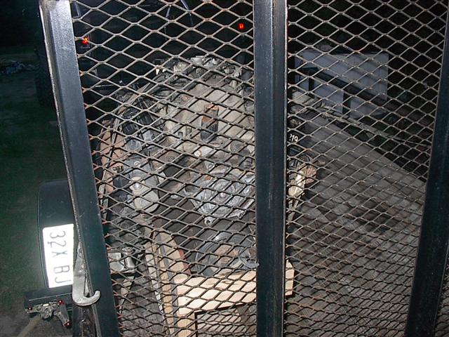 Engine block behind metal mesh, with license plate 32X BJ visible