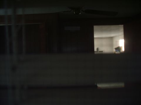 1978 Ford Bronco - Interior view showing a ceiling fan and a window looking into an adjacent room.