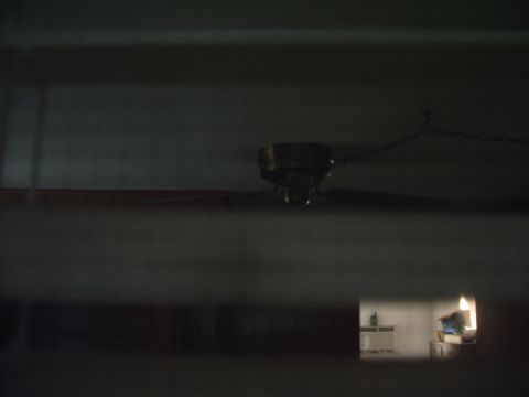 1978 Ford Bronco - A ceiling fan is visible in the foreground, with a glimpse of a room containing a television in the background.