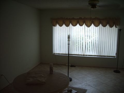 1978 Ford Bronco - Room interior with window blinds, a floor lamp, and a round table.