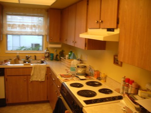 1978 Ford Bronco - A kitchen scene with wooden cabinets, a sink, and a stove is shown.