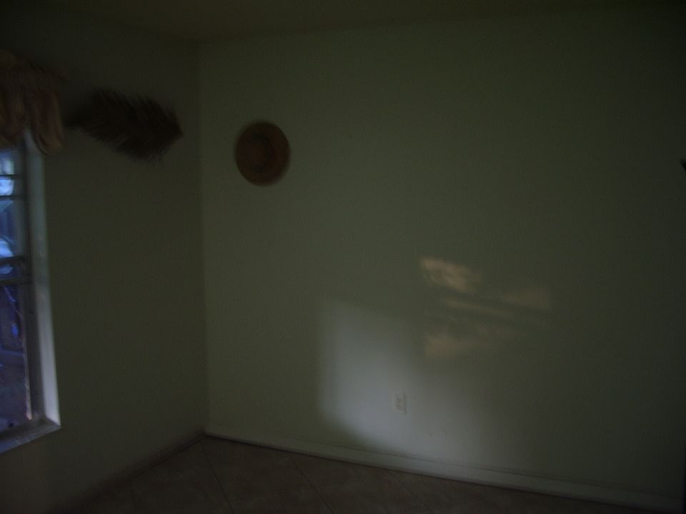 Interior room with a window on the left and a circular decoration on the wall