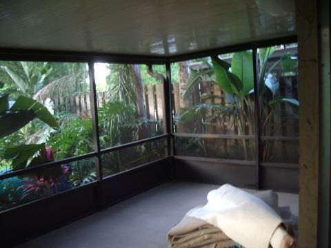 1978 Ford Bronco - A screened porch overlooks a lush, tropical garden area.