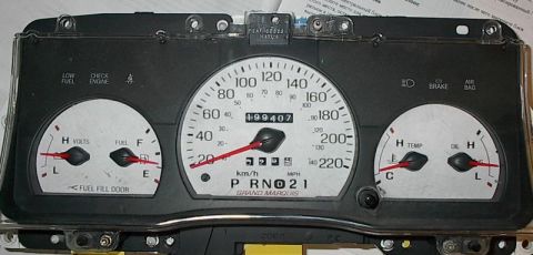 1985 Mercury Grand Marquis - This is a close-up of a car's instrument cluster, showing various gauges and the odometer reading 99,407.