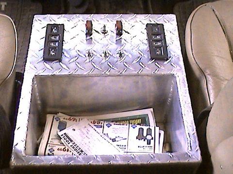 1978 Ford Bronco - Custom center console with switches and papers, likely an aftermarket addition.