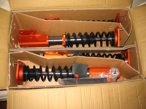 1994 Ford Probe - New coilover suspension parts are packaged in a cardboard box, ready for installation.