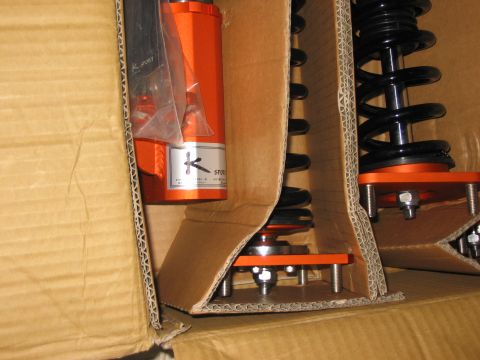 1994 Ford Probe - K-Sport coilover suspension parts are shown packed in a cardboard box.