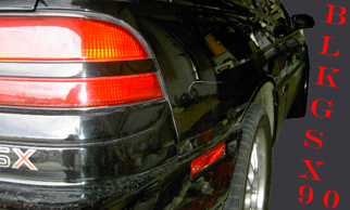 1990 Mitsubishi Eclipse - Rear view of a black 1990 Mitsubishi Eclipse, showing the 'GSX 90' badging.