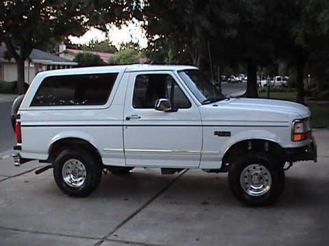 1994 Ford Bronco - This 1994 Ford Bronco is shown from the side, parked on a driveway.