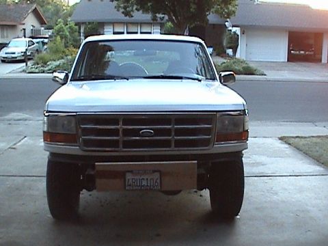 1994 Ford Bronco - Front view of a Ford Bronco, likely a 1992-1996 model, with a custom wooden bumper extension.