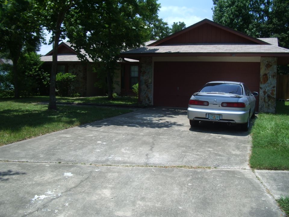 Silver sedan parked in front of a garage