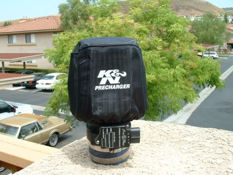 1992 Ford Crown Victoria - A K&N Precharger air filter cover is shown in front of trees and buildings.