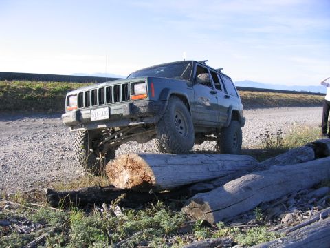 2000 Jeep Cherokee - This Jeep Cherokee is navigating an obstacle course of fallen logs on a gravel road.