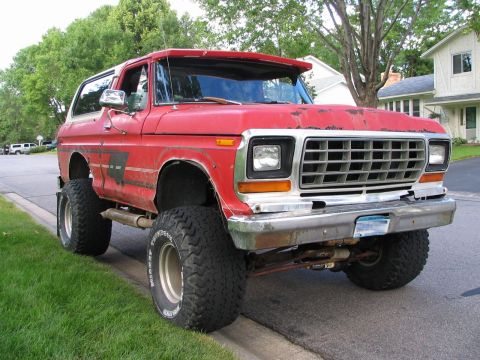1978 Ford Bronco - This lifted 1978 Ford Bronco is parked on the side of a street with houses in the background.