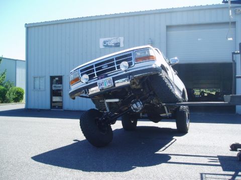 1995 Ford Bronco - This lifted Ford truck is on a lift, showing off its suspension modifications.