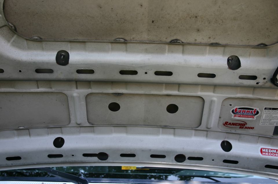 Underside of white hood with slotted bracing and Summit, Rancho RS5000, and Hedman stickers