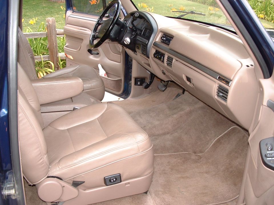 Interior of a 1994 Ford Bronco showing tan leather seats and dashboard