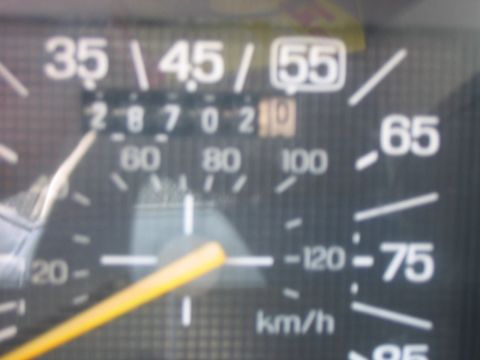 1986 Ford Bronco - Vehicle's interior gauge cluster showing odometer reading and speedometer.