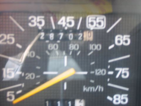 1986 Ford Bronco - Close-up of a vehicle's dashboard gauge cluster, showing speed and odometer readings.