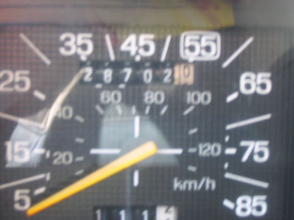 Vehicle speedometer with yellow needle pointing to 35 mph, odometer shows 287021
