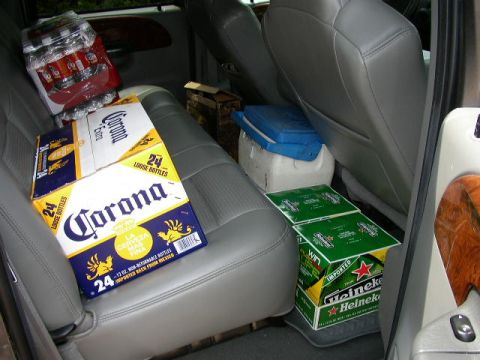 1995 Ford Bronco - Cases of beer and a cooler are stored on the seats inside a vehicle.